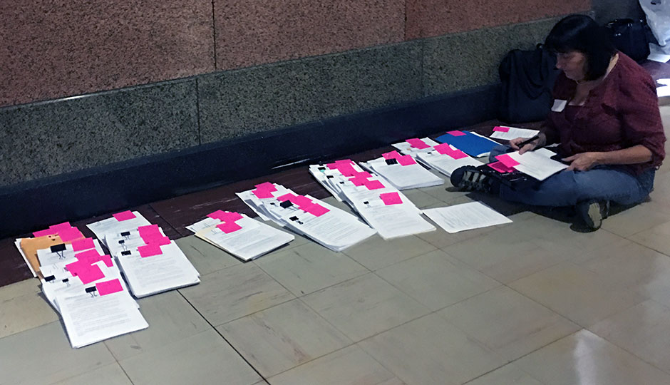 woman with papers on floor — recount petitions