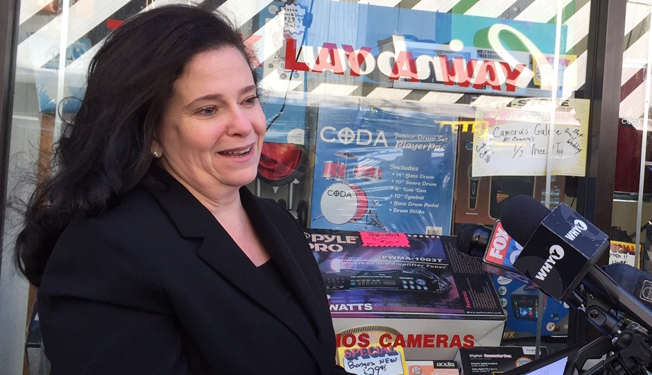 Former city prosecutor Beth Grossman announces her candidacy in front of a Kensington pawn shop where her family once owned a candy store.