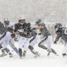 Nick Foles (9) hands off to running back LeSean McCoy (25) during the second quarter against the Detroit Lions at the Lincoln Financial Field Snow Bowl