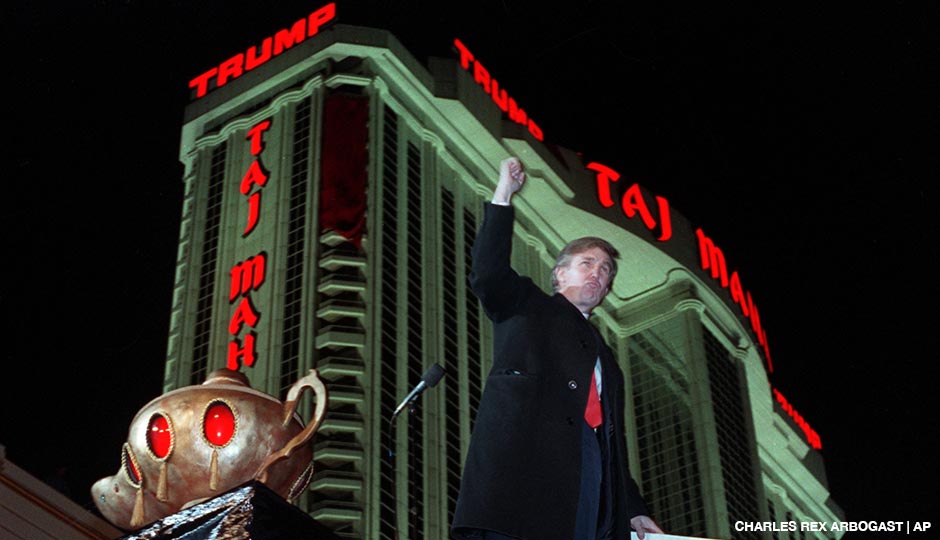 Donald Trump ascends the stairs with his fist raised after the opening of the Trump Taj Mahal Casino Resort in Atlantic City, N.J. on April 5, 1990.