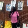 Ramona Africa standing in front of posters supporting Mumia Abu-Jamal