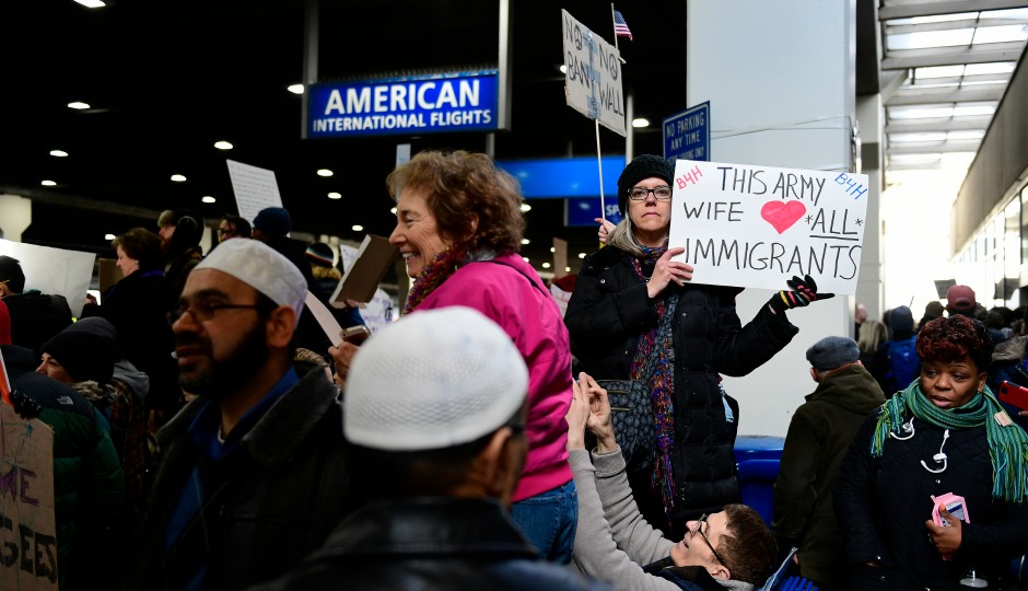 Johanna Noonan, of Philadelphia, holds up a sign during a protest of President Donald Trump's executive order banning travel to the U.S. by citizens of several countries Sunday, January 29th, 2017, at Philadelphia International Airport in Philadelphia. (AP Photo/Corey Perrine)