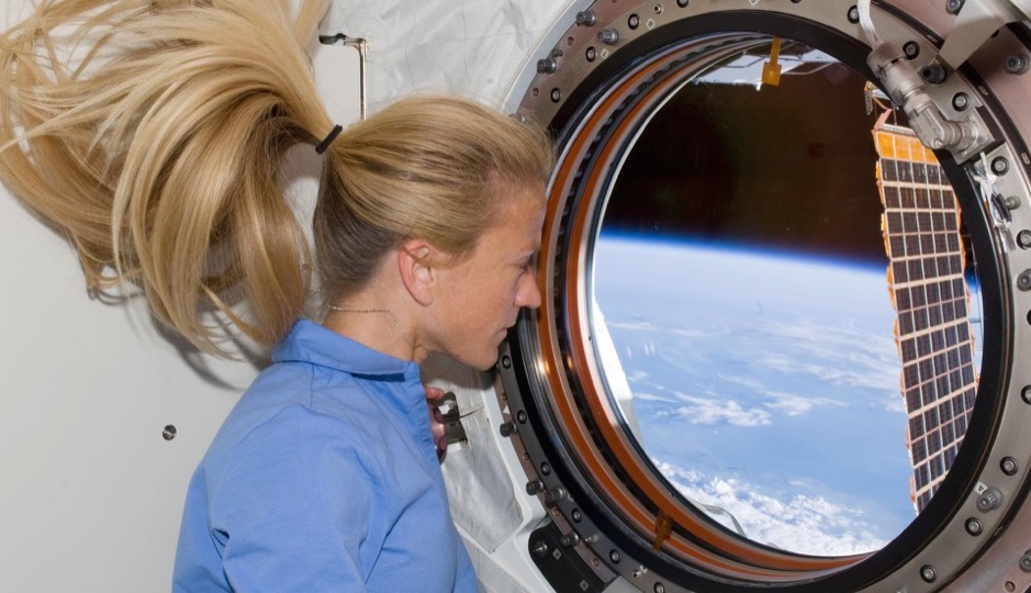 S124-E-008613 (10 June 2008) --- Astronaut Karen Nyberg, STS-124 mission specialist, looks through a window in the newly installed Kibo laboratory of the International Space Station while Space Shuttle Discovery is docked with the station.