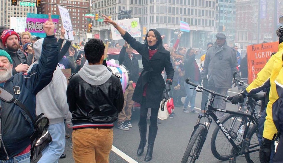 Sharron Cooks guiding people away from the anti-trans bus | Photo by Jennifer Bryant