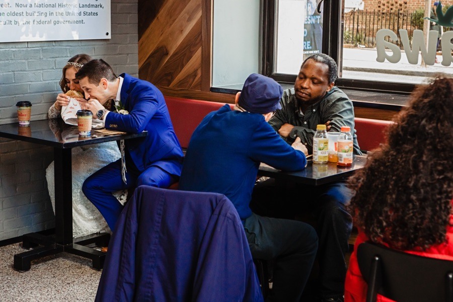 bride and groom eating wawa hoagies