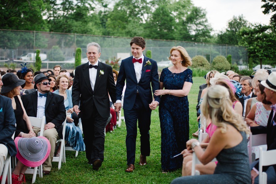 groom walking parents down aisle