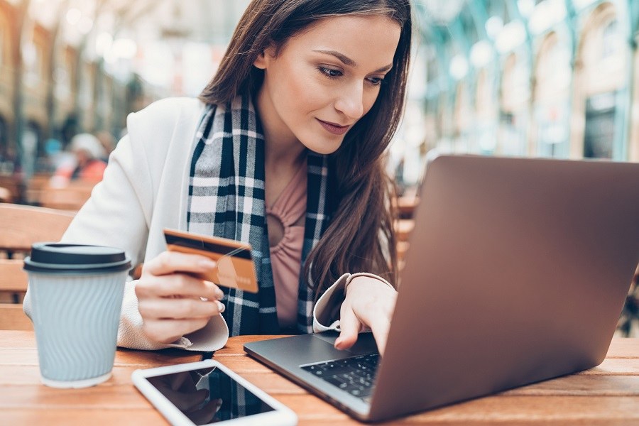 Elegant woman with credit card and laptop