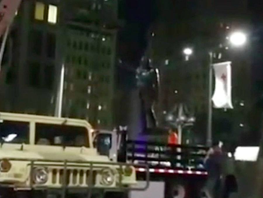 the frank rizzo statue being removed by a crane into a truck