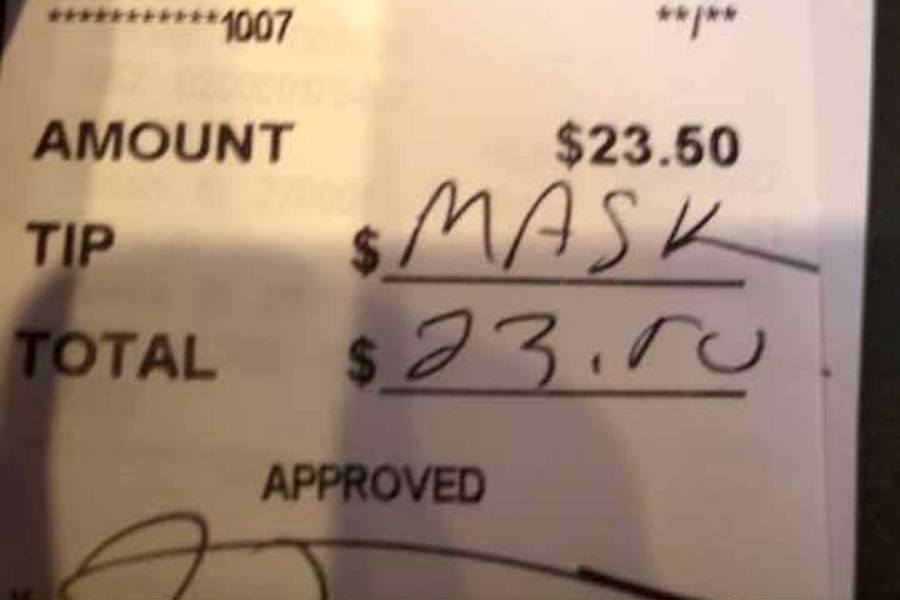 A credit card slip from John Henry's Pub, a restaurant in Ardmore. The customer who signed it was apparently unhappy that his server had asked him to wear a mask while not seated. (Photo via John Henry's Pub)