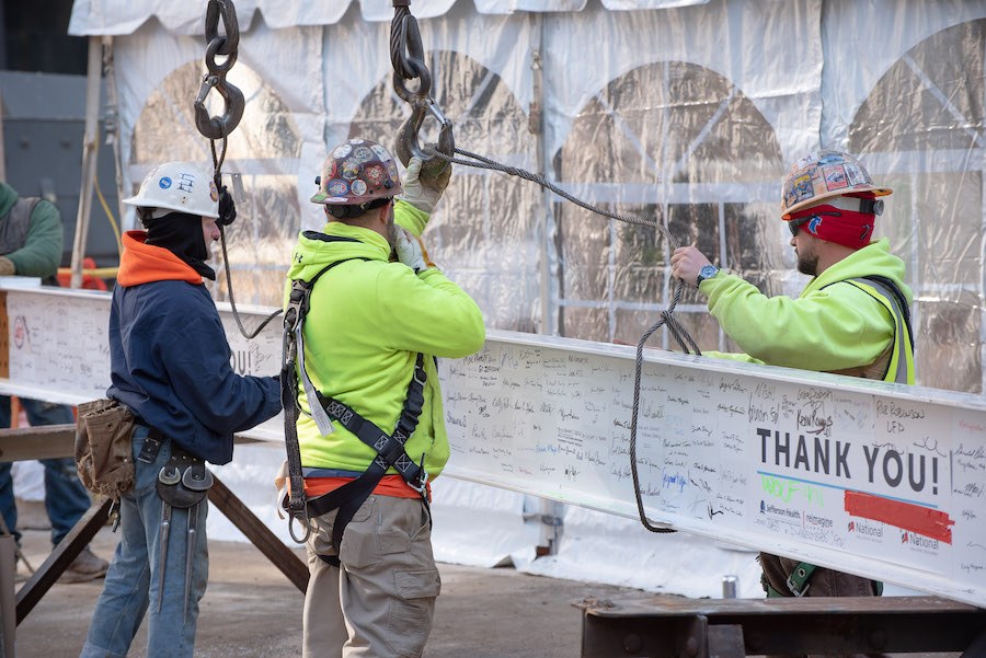jefferson topping off east market workers preparing beam for hoisting
