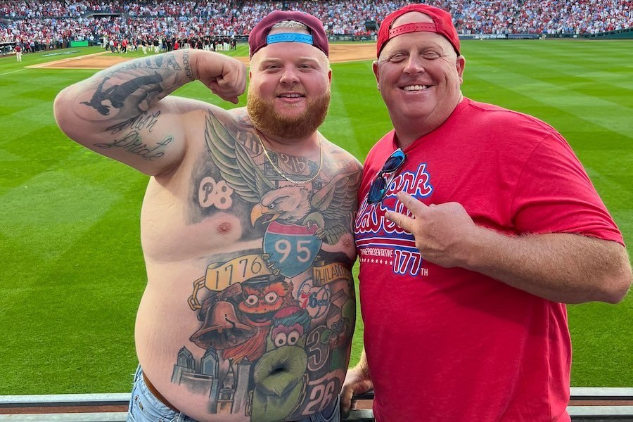 Philadelphia sports fan Rob Dunphy showing off his philadelphia eagles and phillies tattoos, which he says he plans to add to if we win the world series