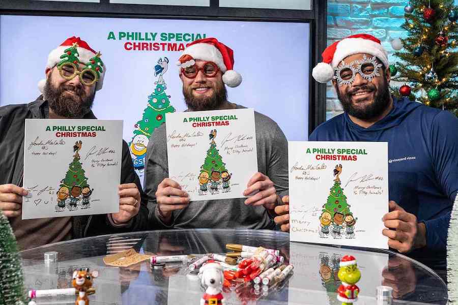 philadelphia eagles players holding copies of the eagles christmas album, a philly special christmas