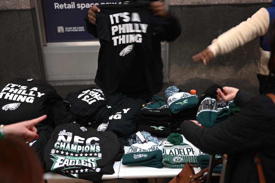 a street vendor selling philadelphia eagles gear ahead of the super bowl between the philadelphia eagles and the kansas city chiefs