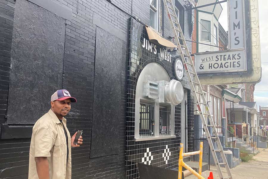 Cortez Johnson, the owner of the Jim's West cheesesteak shop in Philadelphia in front of Jim's West while it was under construction
