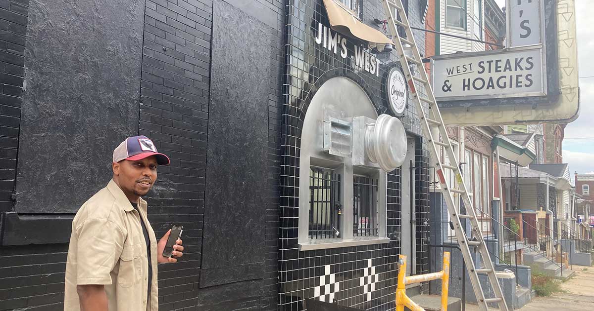 Jim's West owner Cortez Johnson in front of his West Philadelphia cheesesteak shop before it opened in 2023 and before Jim's Steaks in Delco filed a lawsuit against him