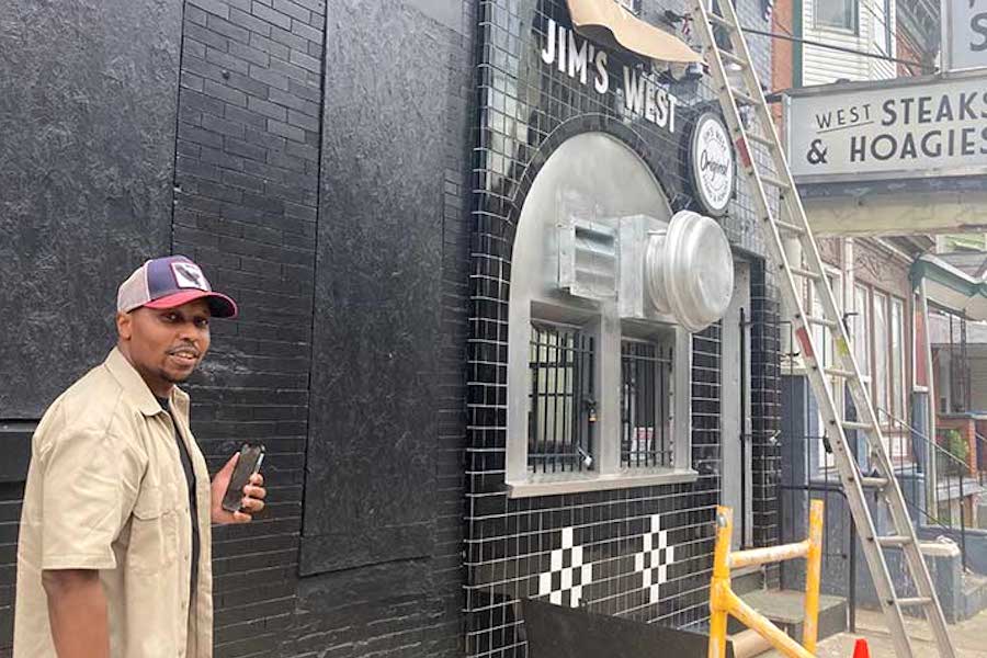 Cortez Johnson, the owner of West Philly cheesesteak shop Jim's West, seen in front of his shop in the days leading up to his opening