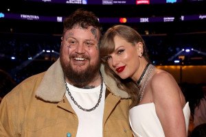 Jelly Roll, seen here at the Grammys with Taylor Swift earlier this year, is the subject of a new lawsuit filed by the Delco wedding band Jellyroll