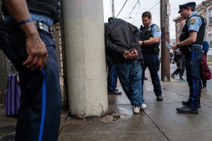 Philadelphia police officers arrest someone during a May crackdown in Kensington.