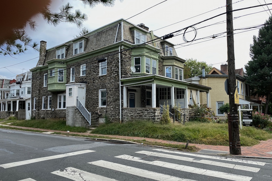 house with overgrown front lawn