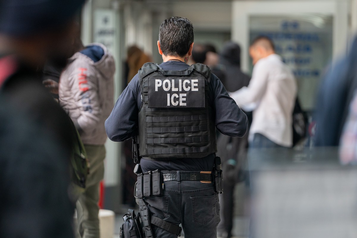 Pictured is an unidentified ICE agent, as rumors of ICE raids swirl in Philadelphia's migrant community